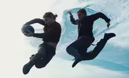 two people are playing with a ball in the water