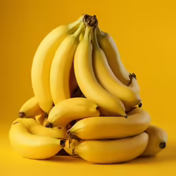 a bunch of bananas with some brown spots on them