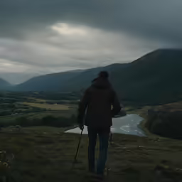a person in a brown coat is on some grass