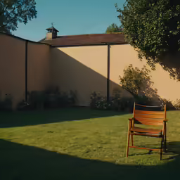 a lonely wooden chair is in the front yard