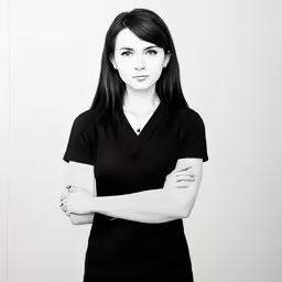 a female with her arms crossed, posing for a portrait