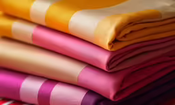 multi colored pieces of cloth stacked on each other