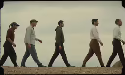 the group of men are walking along together