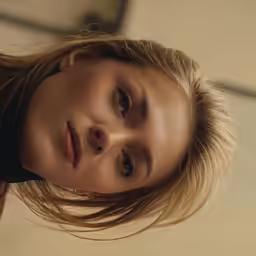 the young woman has long hair on her face