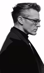 a black and white photograph of a man with glasses on his head