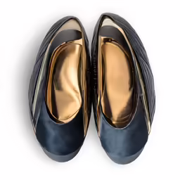 a pair of womens blue shoes on top of a white surface