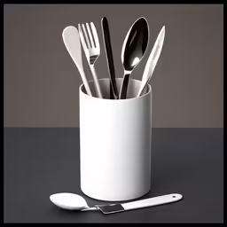 there are spoons, forks and knives in this cup