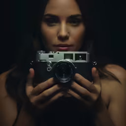 a woman holding a camera in her hands