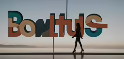 silhouette of woman walking in front of logo for bontish