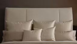 a bed that has some pillows on it