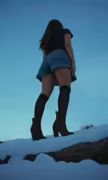 a women in jeans shorts and boots looking off into the distance