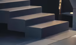 a number of steps that are set on a tiled floor