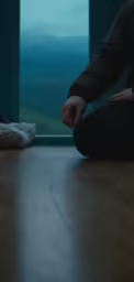 a person sitting on the floor stretching their arms