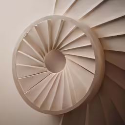 a circular object in white that is on the wall