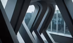a room with an artistic sculpture next to large windows