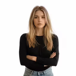 a woman with her arms crossed looking at the camera