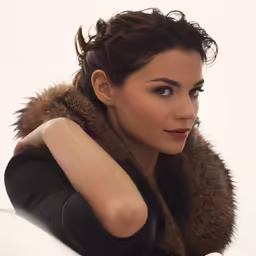 the woman has a very large hair and is wearing a furry collar