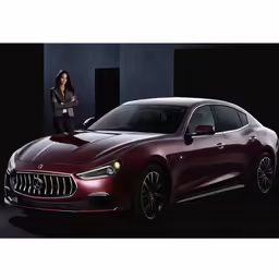 a woman in a black jacket standing next to a red sports car