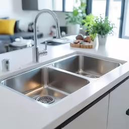 a large white kitchen with a sink under the faucet