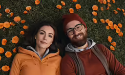 a couple poses for a portrait surrounded by flowers