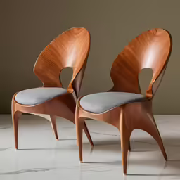 two wooden chairs are sitting next to each other