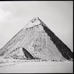 an old mountain with snow on it, and sky