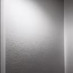 the back side of a white refrigerator freezer in a corner