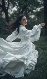 the woman in white is posing on grass
