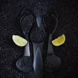 four pieces of fruit are seen with a knife and a lemon slice