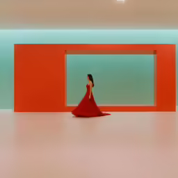 a woman in a red dress walking through an open room