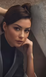 a woman with very short hair poses for the camera