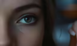woman using cell phone with blue eyes on screen