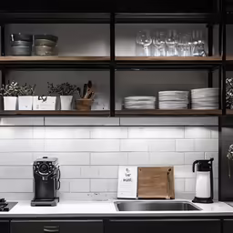 a large kitchen filled with shelves and appliances