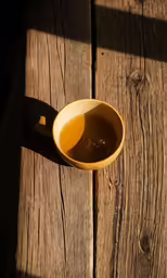 a brown bowl sitting on top of a wooden table