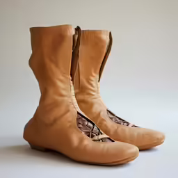 a pair of brown shoes with laces are shown
