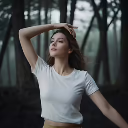 a woman poses in front of the woods