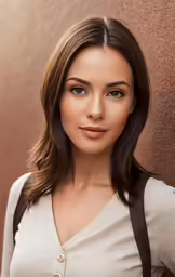 an attractive young woman standing by a wall