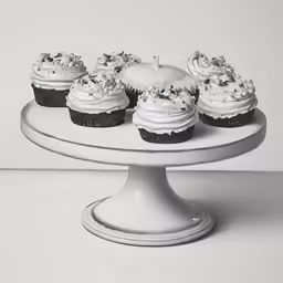 a close up of cup cakes on a cake stand