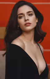 a woman wearing black with large breast posing for the camera