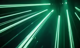 lights streak through the dark and green light