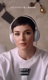 a girl is sitting down and listening to music