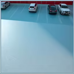 cars are parked in a parking lot next to a building