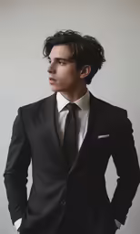a person wearing a suit and tie posing