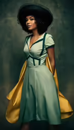 the black woman in green dress is wearing a large black hat