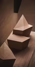 several triangular shapes stacked on a wood table