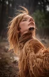 a girl with long hair standing outside in the rain