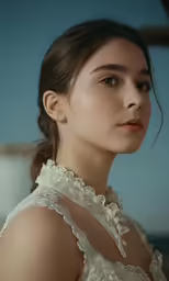 a woman poses for a portrait in a dress