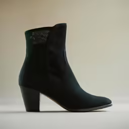 a pair of black boots sitting on top of a table