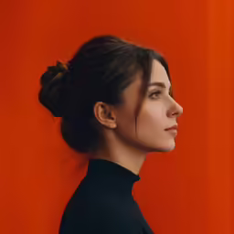 an profile view of a woman in a black shirt