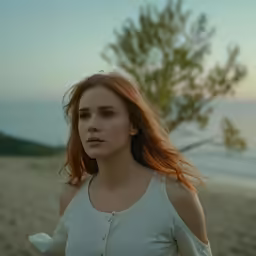 woman standing on beach with blurry body in background